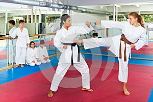 Girl sparring with karate trainer