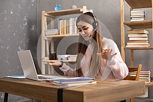 Girl speaking in headphones thinking idea solitions. Student woman online larning photo