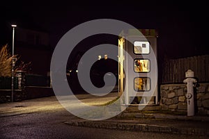 girl speaks in the night telephone booth. mystical and mysterious street phone