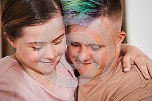 Girl with special needs embracing tight her boyfriend with colored hair