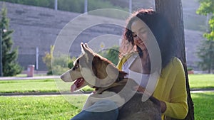 Girl spending lovely summer day with dog outdoors