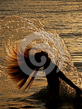 Girl splashing the sea water