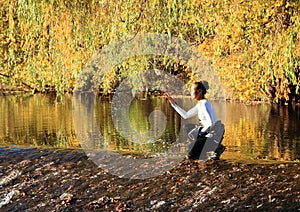 Girl splashing water on weir photo