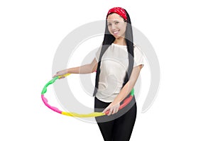 A girl in sport suit with hula hoop