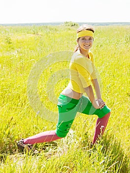 Girl in sporting suit exercising