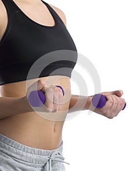 Girl in sports suit with beautiful purple fitness dumbbells.
