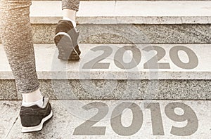 Girl in sports uniform running around. Healthy way of life, an infused figure. sneakers close-up, finish 20189 Start to new year