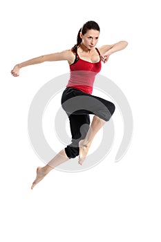 Girl in sportswear jumping over white