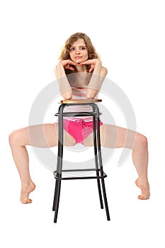 Girl in sportswear leans against bar stool