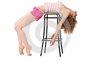 Girl in sportswear lies on bar stool