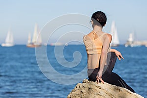 Girl in sportswear observes yachting regatta