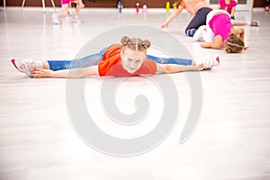 Girl sportswoman dancer 7-9 years old is engaged in sports fitness, does stretching