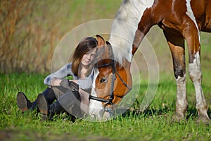 Girl sportswoman and her horse in the spring