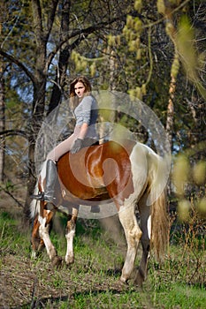 Girl sportswoman and her horse in the spring