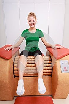 Girl in sportwear on relax massage equipment healthy spa salon