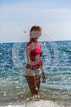 girl in sportwear and tanga in water