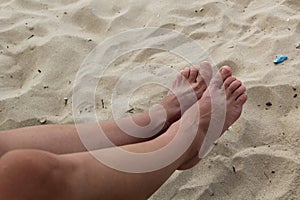 The girl spread her toes. In the frame two legs