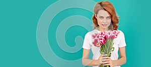 Girl with spring tulips flowers. woman with fresh tulip flower bouquet on blue background. Woman isolated face portrait