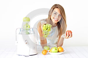 girl squeezes the juice from the juicer photo