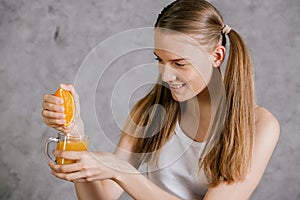 Girl squeezing orange