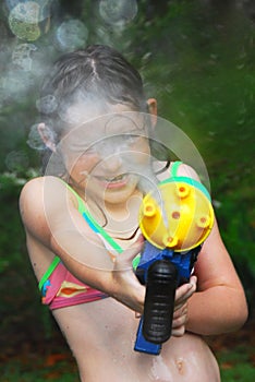 Girl with squirt gun photo