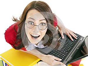 Girl with stack color book and laptop.