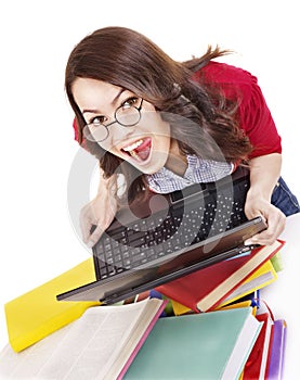 Girl with stack color book and laptop.