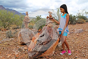 Girl stacking rocks