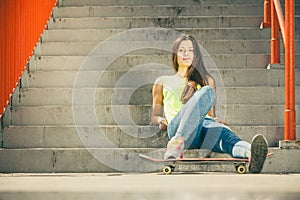 Girl on stairs with skateboard.