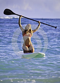 Girl on a stand up paddle board