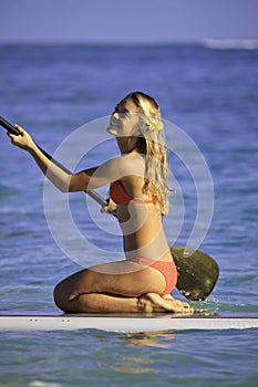 Girl on a stand up paddle board