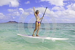 Girl on a stand up paddle board