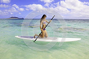 Girl on a stand up paddle board