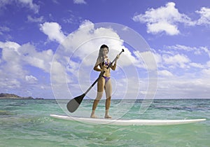 Girl on a stand up paddle board