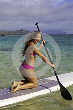 Girl on stand up paddle board