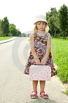 Girl standing alone on the roadside