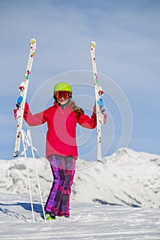 Girl standing with arms spreading wide open on the fresh powder