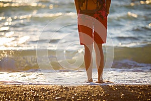 Girl standing back on beach