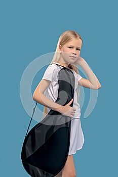Girl standing with bag for tennis rackets