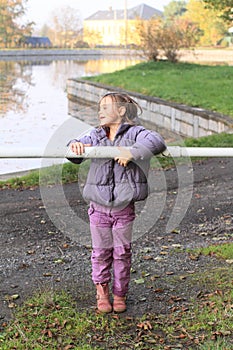 Girl standing behind banisters