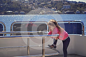 Girl standing on board of the yacht. Vacation on a yacht. Cruise on the ship. Journey across the ocean.