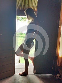 Girl standing in doorway in bikini