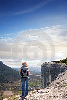 A girl standing on the edge of the high mountain