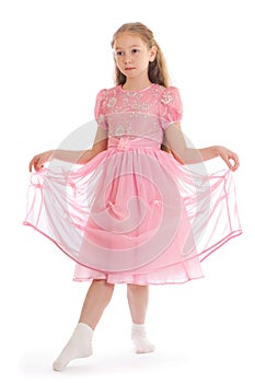 Girl standing on floor in ball dress makin curtsy