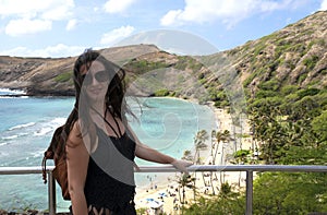 A girl standing a front of the ocean