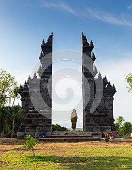 Girl is standing in the gate of Pura Lempuyang temple on Bali island, Indonesia