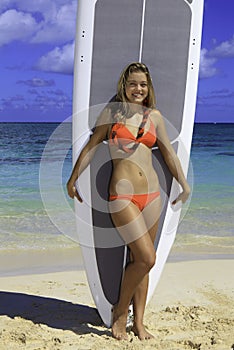 Girl standing with her paddle board