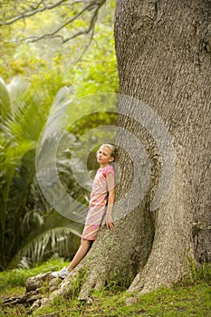 Girl Standing by Large Tree