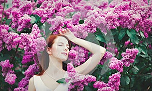 Girl standing near lilac bushes in the park