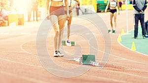 Girl standing near starting blocks before sprint